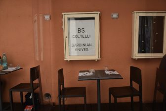 Italy-Sardinia-Alghero-restaurant-Trattoria da Mirko-table-chairs-plastic sheets