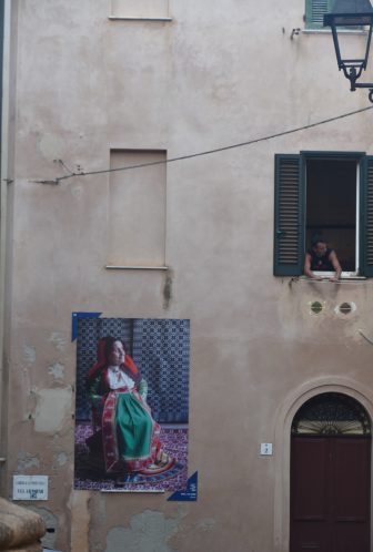 Italy-Sardinia-Alghero-photograph-old woman-costume-window-person-lamp