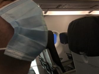 England-in the air-in the aeroplane-surgical mask-seat-empty