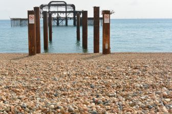 the wreckage of the pier in Brighton seen from the beach
