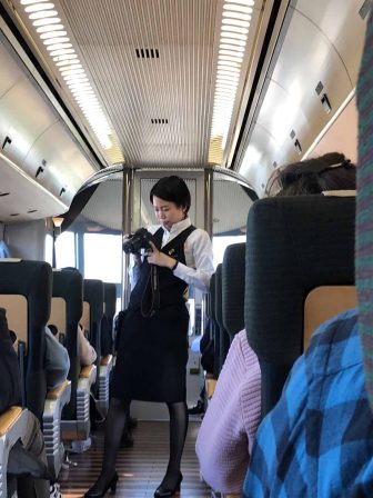 Japan-Kyushu-Oita-limited express train-"Yufuin no Mori"-inside-woman-taking photos