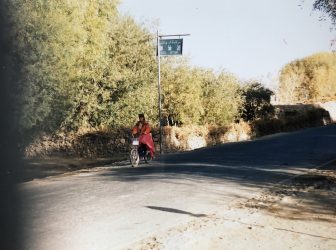 China-Tashkurgan-Tajik woman-hat-cycling