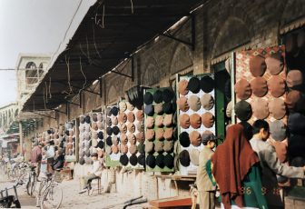 China-Kashgar-bazaar-hat shops-woman-brown scarf