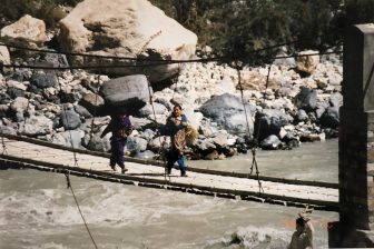 Pakistan-from Sust to Karimabad-Karakorum Highway-people-crossing-suspension bridge-river