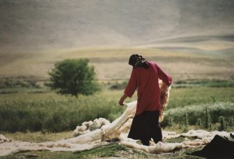 Iran-Kermanshah-woman-fleece-grassland