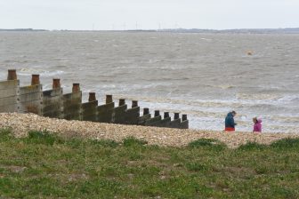 England-Whitstable-sea-groyne-people