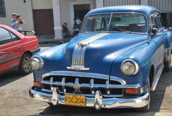 a blue classic car parked in Cienfuegos