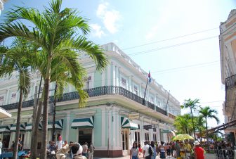 on the corner of the town of Cienfuegos with many people