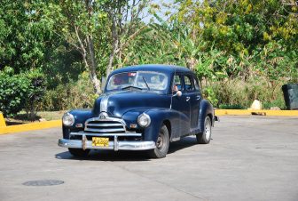 A classic car parked at a petrol station in Cuba