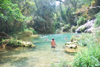 tourists bathing in the basin of the waterfall in Topes de Collantes, Cuba