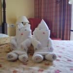 two dolls made of towels on the bed in a room in the hotel in Trinidad, Cuba