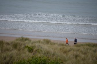 people walking along the coast of Northumberland