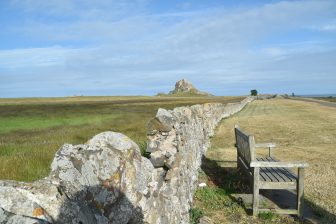 long stone wall and Lindisfarne Castle on Holy Island
