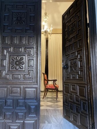 the suite room and the traditional doors of Palacio Marques de la Gomera, the mansion in Osuna