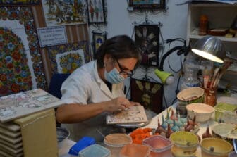 a woman demonstrating in a ceramic shop where we did shopping in Seville