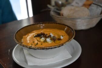 a soup dish with ham at Taberna Aquilas, a tapas bar in Seville