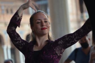 a flamenco dancer performing at Plaza de España in Seville