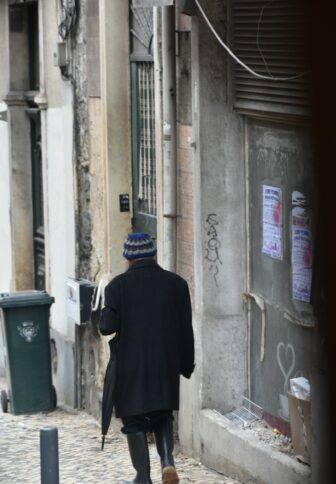 a walking person seen from tram No.28 in Lisbon