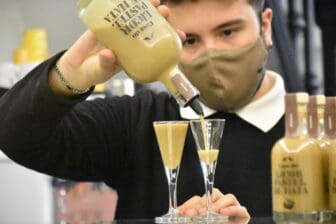 a person pouring a liqueur of Nata in Lisbon