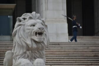 an lion statue and the guard at the Parliament Building in Lisbon 