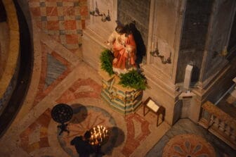 a man lighting the candle inside Estrela Basilica in Lisbon