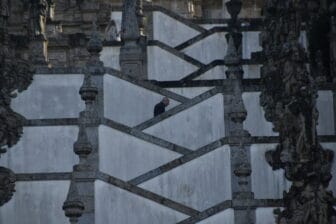 a person climbing up the stairs of Bom Jesus do Monte in Braga