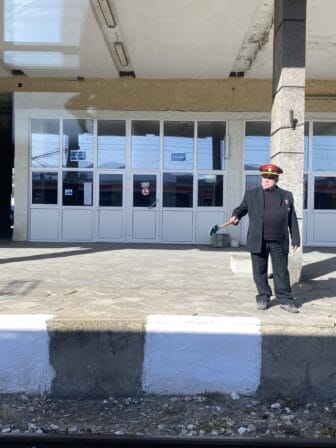 a station master on the platform of a station between Plovdiv and Sofia