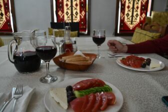 salad and wine served in the guesthouse in Chiprovtsi, Bulgaria