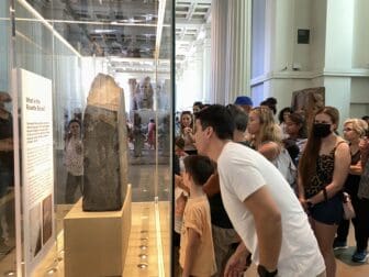 people looking at the Rosetta Stone at British Museum