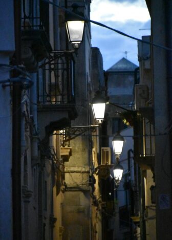 an alleyway in Syracuse after sunset