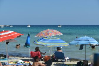 colourful parasols at the free part of Fontane Bianche beach near Syracuse