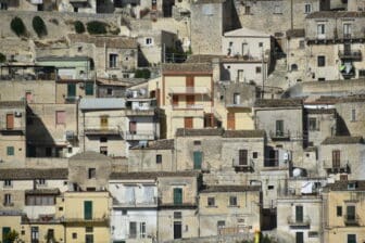 close up of the view of Modica in Socily with many houses on the hill