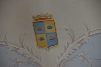 the family crest of Arezzo family seen in the Baron's mansion