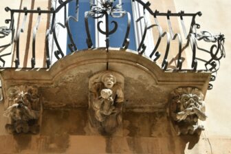 example of the sculptures under the balcony in Ragusa Ibla in Sicily