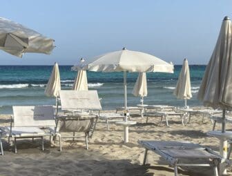 white parasols and chairs on Fontane Bianche beach