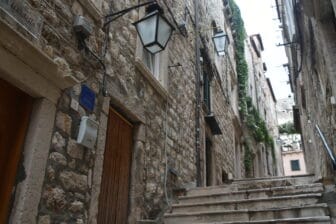 street lights and stone buildings along the staircase in Dubrovnik, Croatia