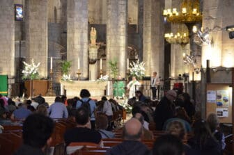 the priest and the believers in Basilica de Santa Maria del Mar in Barcelona, Spain