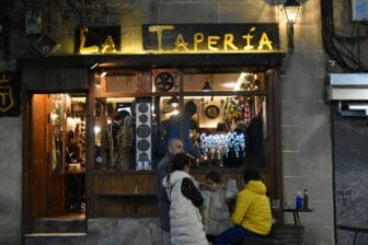 the exterior of La Taperia, a restaurant in Caceres at night