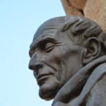 the face of Torre de Bujaco, statue outside of the cathedral in Caceres, Spain