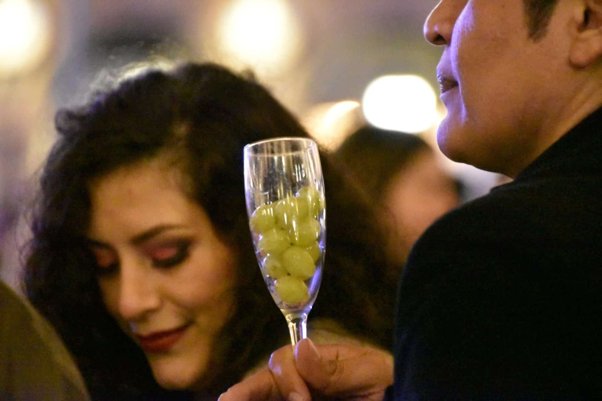 people with a glass of grape on New Year's Eve in Salamanca, Spain