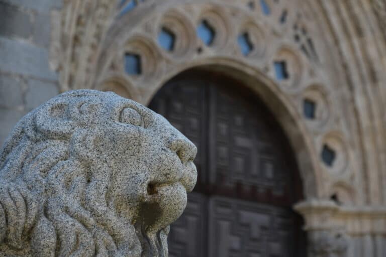 statue of a lion outside of the cathedral in Ávila, Spain