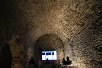 people watching the screen at the end of Cryptoporticus in Aosta, Italy