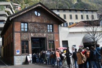 people queuing towards the funicular station in Como in northern Italy