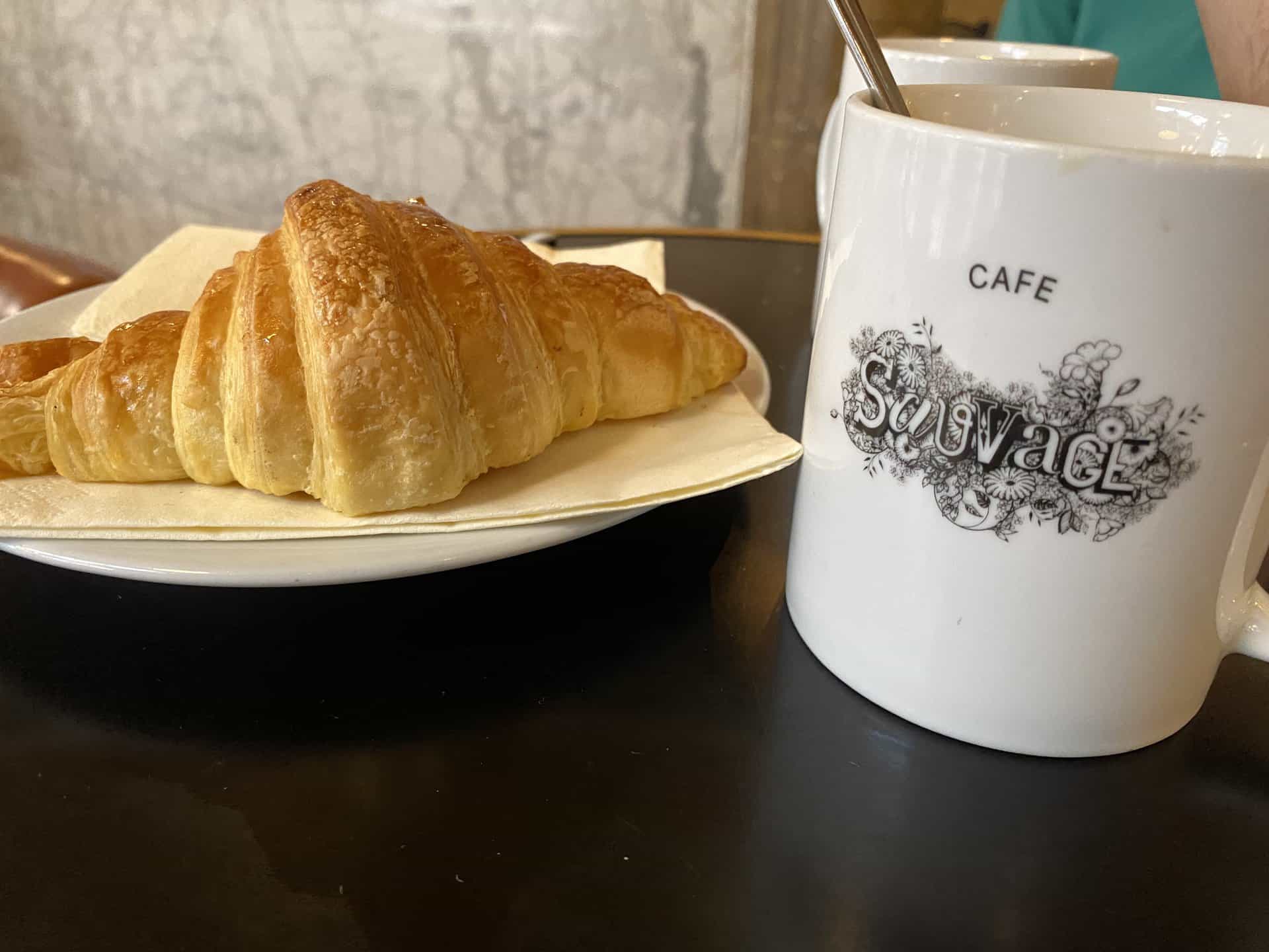 a classic breakfast of cafe au lait and croissant in Paris, France
