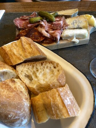 assorted ham and cheese with bread at Le Siffleur de Ballons, the wine bar in Paris, France