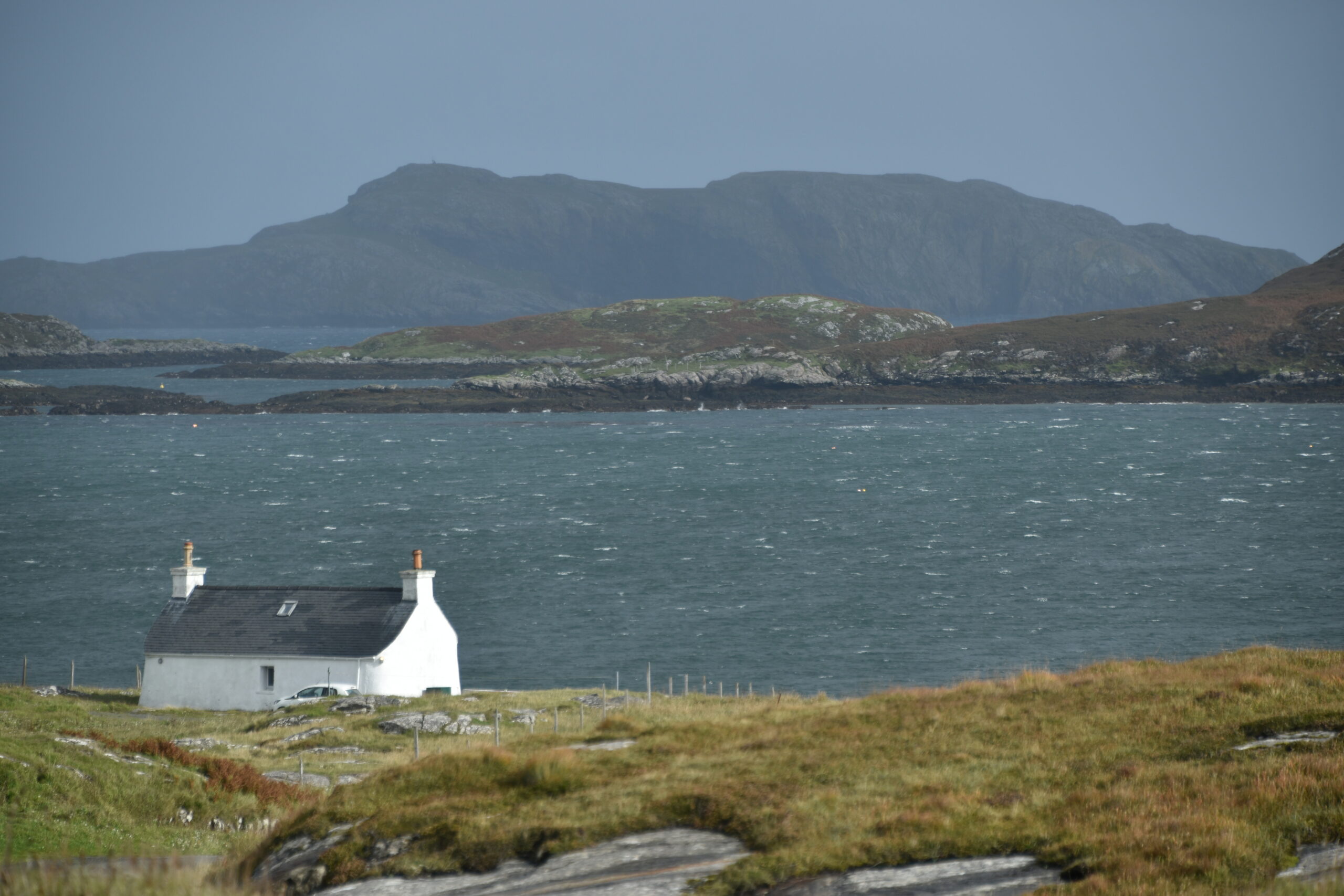 a white cottage on the coast of Barra Island in Hebrides, Scotland