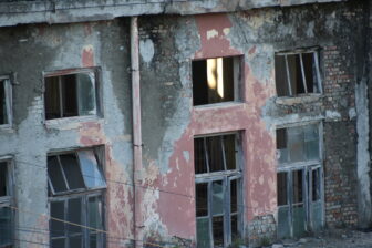 there was an old ruin of a factory next to Grand White City Hotel , a hotel in Berat in Albania