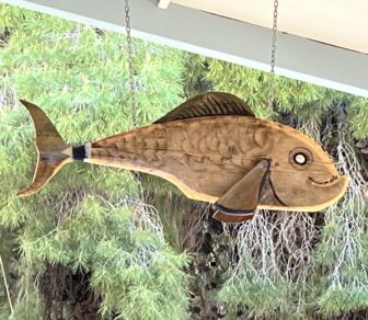 wooden fish hung at the restaurant in Porto Palermo in Albanian Riviera