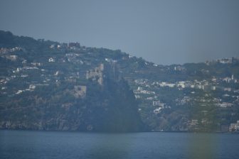 the Aragonese castle on Ischia island seen across the sea from Procida island in Italy