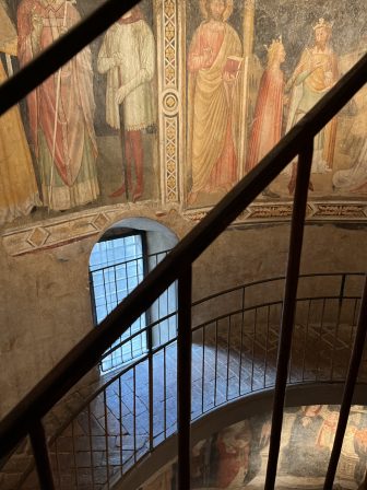 stairs surrounded by frescos towards treasure room of Basilica Santa Maria Maggiore in Bergamo, Italy